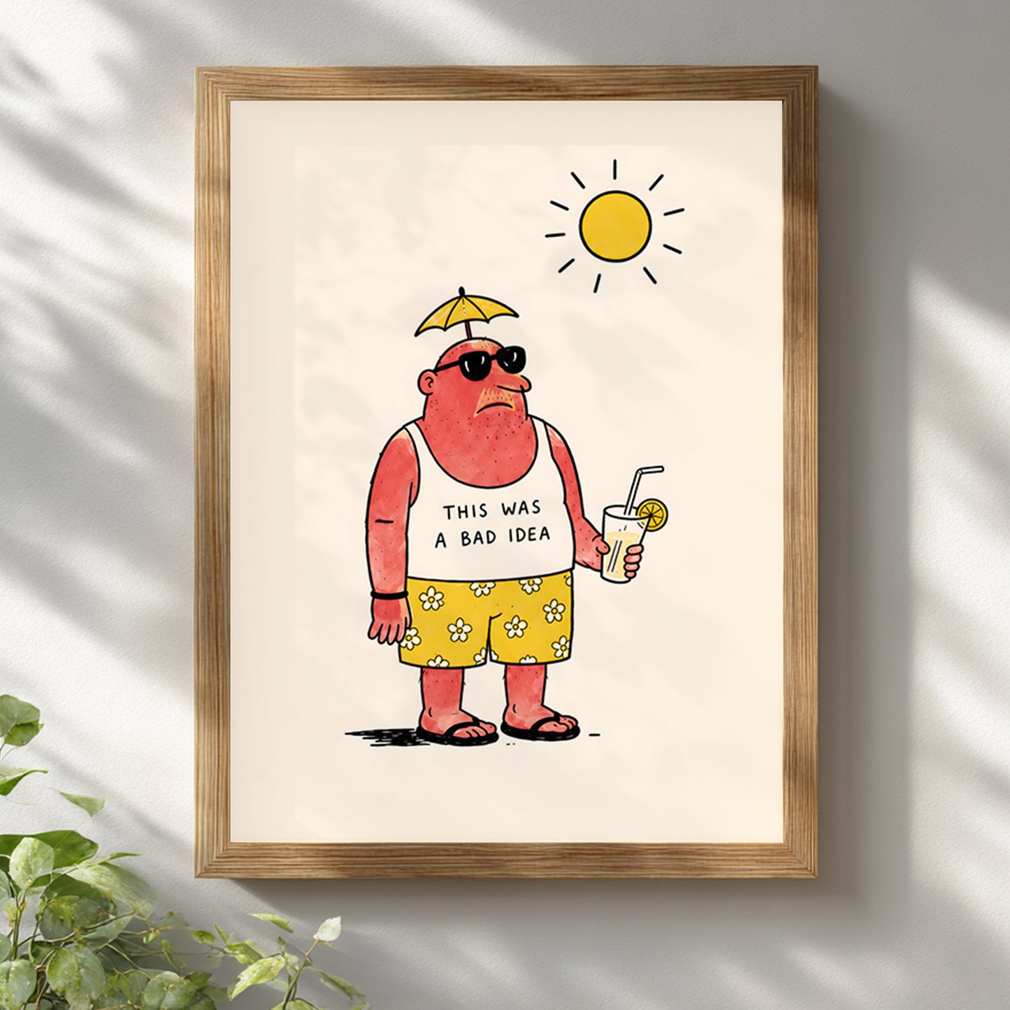 Funny travel poster in a light wooden frame on a white wall with soft greenery around it. The artwork shows a sunburnt man in sunglasses, yellow flower shorts and flip flops, holding a cold drink under a bright sun. A funny holiday print for travel decor, kitchens, bathrooms or home bars.