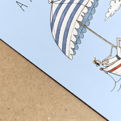 Close-up of the unframed Amalfi poster showing the printed blue parasol, boat illustration, clean paper edge and surface detail against a natural brown background.