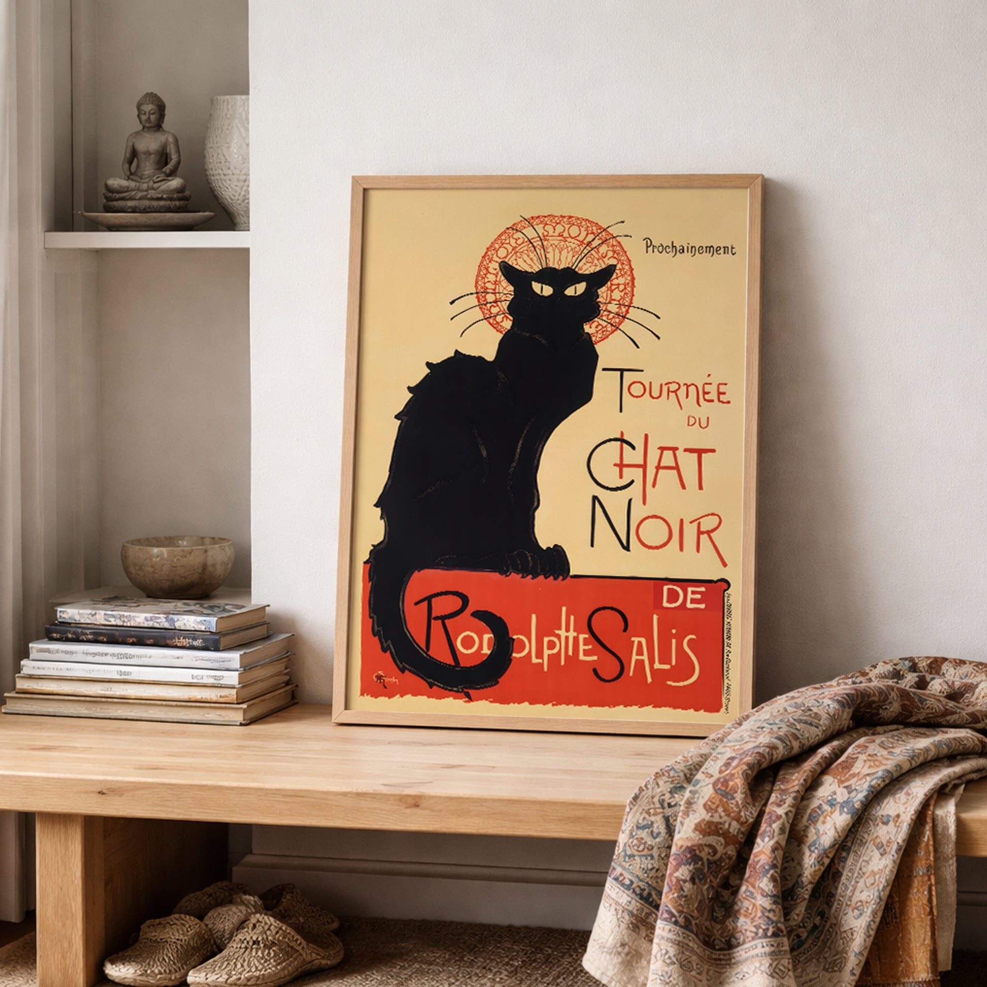 French Chat Noir poster displayed on open shelving with books and folded textiles, highlighting the black cat silhouette and red circular design. The Steinlen Art Nouveau cabaret print introduces Paris theatre heritage into a calm, textured interior. A strong vintage French wall art choice for creative studios, reading spaces or cultural home decor.