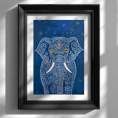 Black framed Blue Elegant Elephant Print displayed on a white wall with soft natural light and window shadows. The artwork shows a front-facing elephant with intricate white pattern lines, large gold eyes, white tusks and a small red forehead detail on a deep blue background. A clean interior mockup for blue elephant wall art, Indian elephant art and decorative animal print styling.