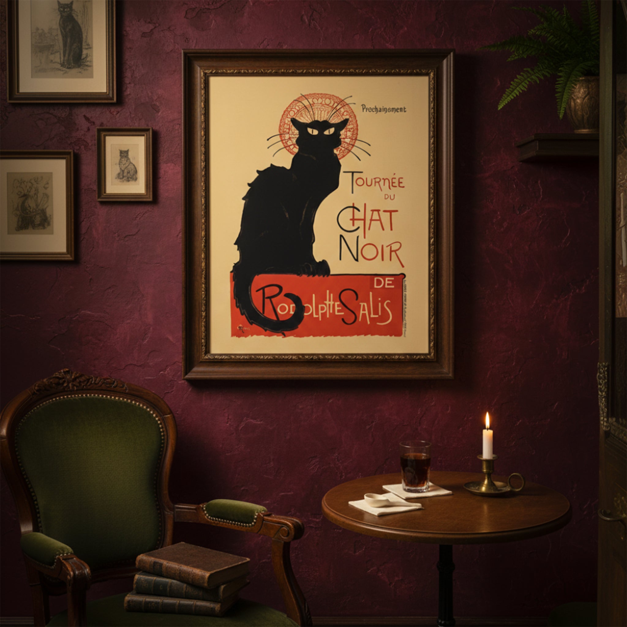 Framed Tournée du Chat Noir poster styled in a moody, vintage-inspired living room with deep red walls, classic green chair and candlelit table. The French Art Nouveau black cat print stands out as a focal point, reflecting bohemian Paris nightlife and historic cabaret culture. A dramatic example of vintage French theatre wall art in a rich interior setting.