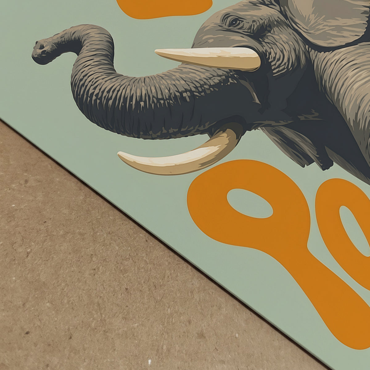 Close-up detail of an elephant art print showing the raised trunk, grey skin texture, large tusk and bold orange lettering on a soft green background. A colourful animal poster with retro safari style, ideal for showing print detail, playful wall decor, African wildlife art and modern elephant home decor.