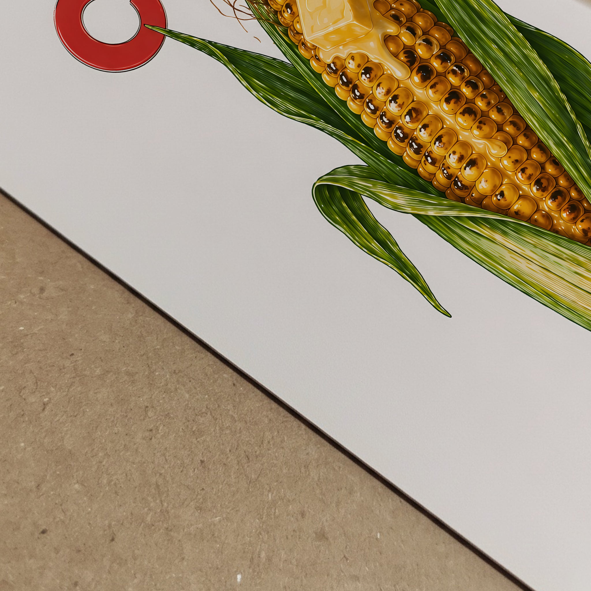 Close-up detail of the corn butter poster printed on paper, showing the edge of the artwork and the corn illustration at an angle. The image highlights the yellow kernels, green husks, red text and clean print finish. A detailed food print, corn wall art and playful kitchen poster.