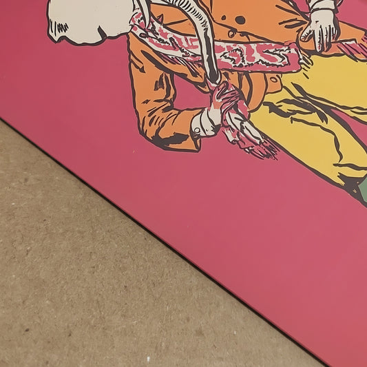Close-up detail of the Elephant Cowboy print showing the lower part of the artwork, paper surface and edge depth. The image highlights the bold red background, yellow trousers, patterned sash and illustrated linework, giving a clearer view of print quality and finish. Useful for shoppers looking for western poster detail, funny animal art texture and cowboy wall art print quality.