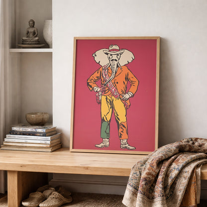 Elephant Cowboy poster styled on a wooden shelf in a neutral room with ceramics, books and textured fabric. The artwork shows an elephant dressed as a cowboy on a rich red background, mixing funny animal wall art with western poster style. Works well in eclectic interiors, home offices, cosy living spaces and gallery walls needing bold Americana character.