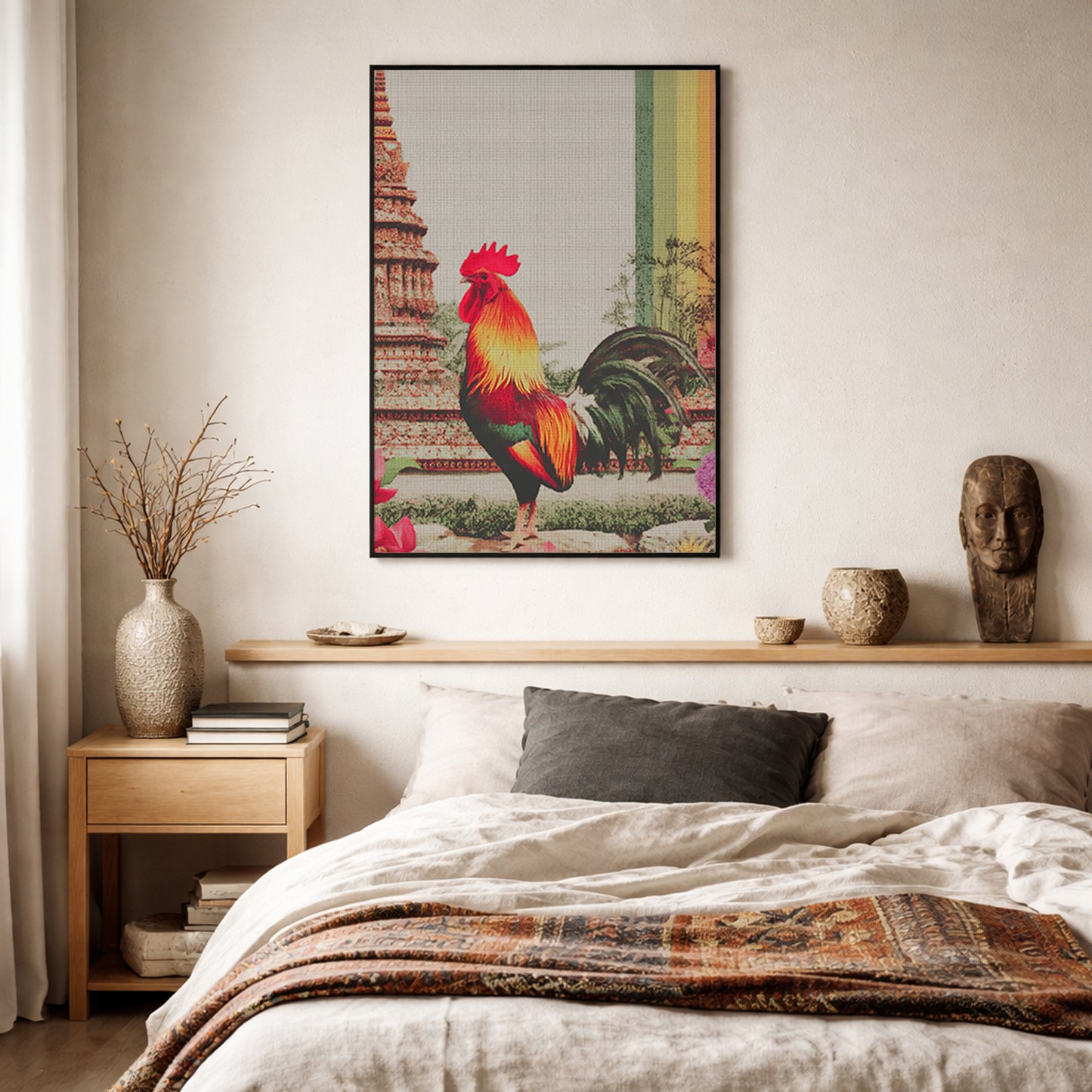 Framed Thai rooster wall art hung above a wooden headboard in a calm cultural bedroom. The print features a bold red and gold rooster, Wat Arun-style temple background, visible canvas texture and a striking rainbow stripe, framed by linen bedding, plants and natural materials for a thoughtful, colourful yet restful interior look.