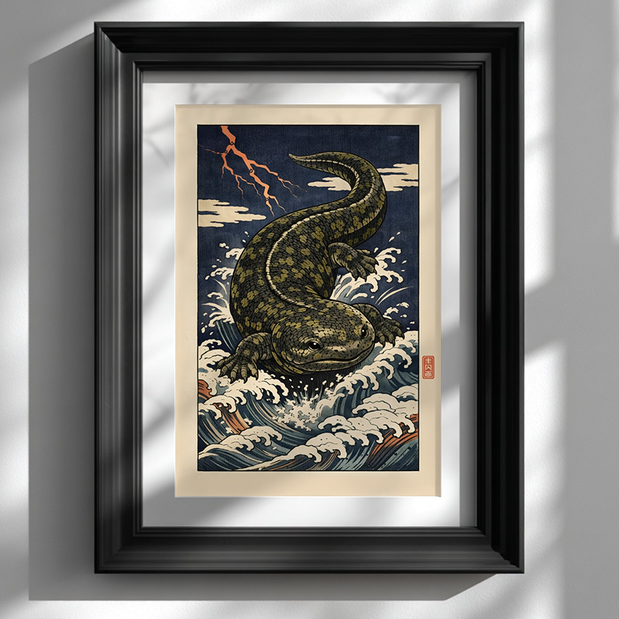 Hanzaki Japanese yokai poster displayed in a glossy black frame on a white wall. The ukiyo-e inspired woodblock digital print shows a mythological giant salamander rising through storm waves under lightning. Japanese folklore wall art styled as modern cultural decor, highlighting strong contrast, bold linework and traditional Edo-style composition.