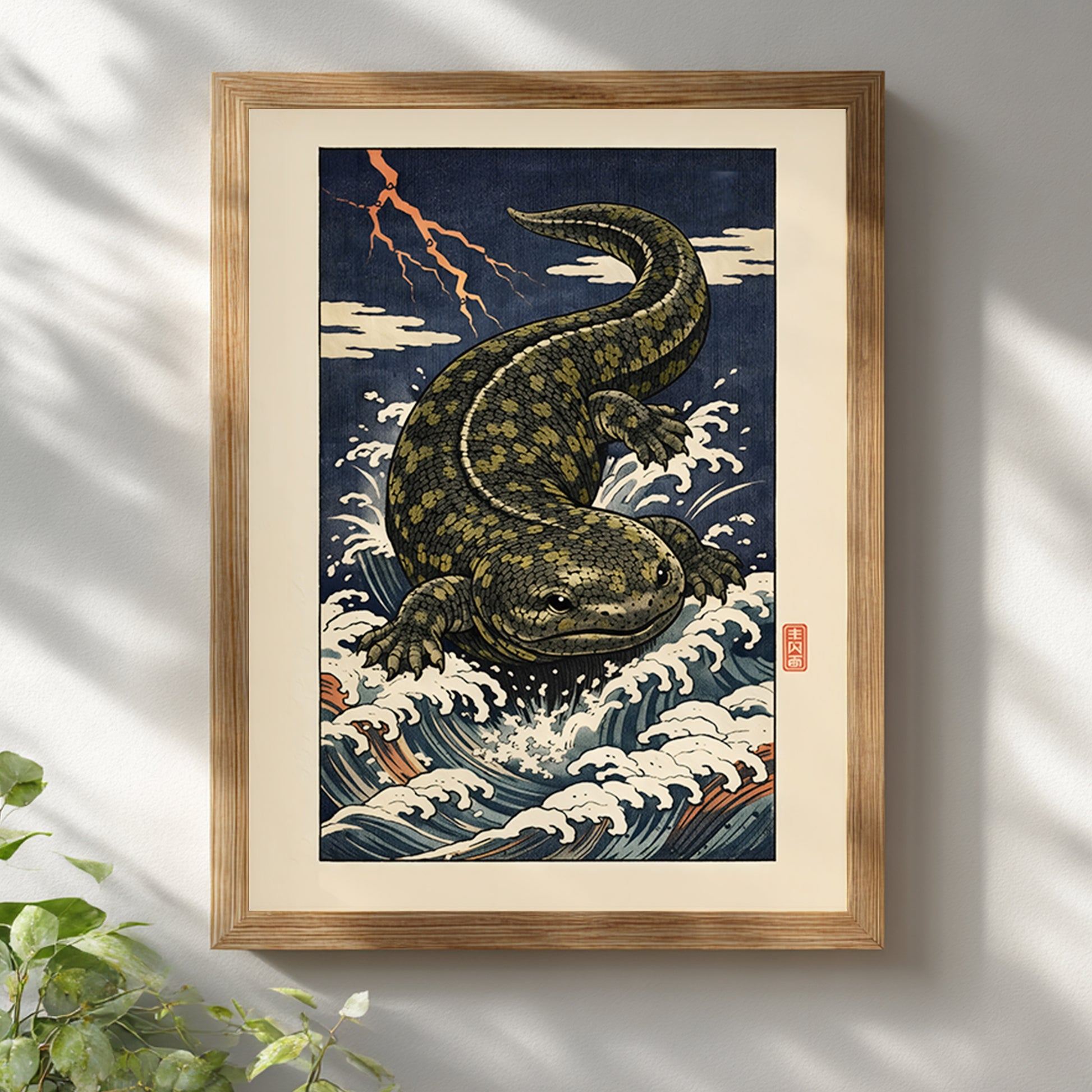 Hanzaki Japanese yokai poster displayed in a light wooden frame against a white wall with soft natural shadows. The ukiyo-e woodblock digital artwork features a mythological giant salamander rising through turbulent river waves beneath lightning. Japanese folklore wall decor combining traditional Edo-era composition with modern presentation.