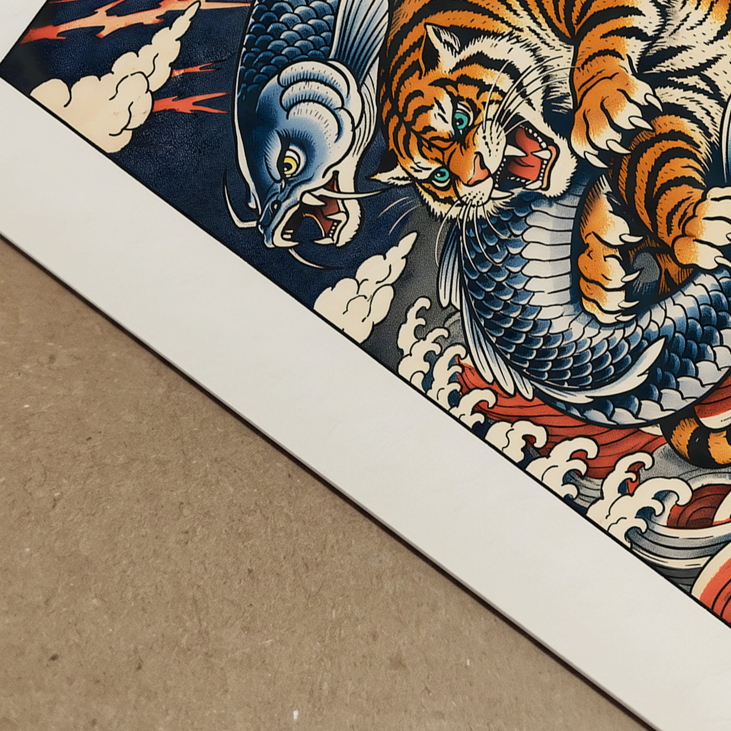Close-up detail of the Japanese tiger and ocean wave art print showing crisp linework, textured paper surface and rich pigment tones. The orange and black striped tiger curves through layered blue waves with cream highlights and red seal accents. This macro view emphasises the intricate woodblock-inspired design and high-quality print finish.