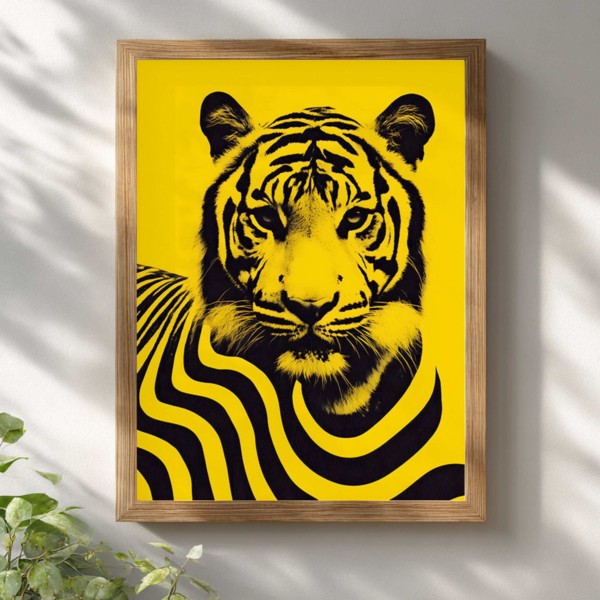 Malaysian tiger wall art poster displayed in a natural wooden frame on a white wall with soft daylight shadows. The artwork features a bold black tiger portrait with flowing striped graphic patterns on a vivid yellow background, creating a contemporary wildlife print inspired by Malaysia’s national animal for modern interior decor.