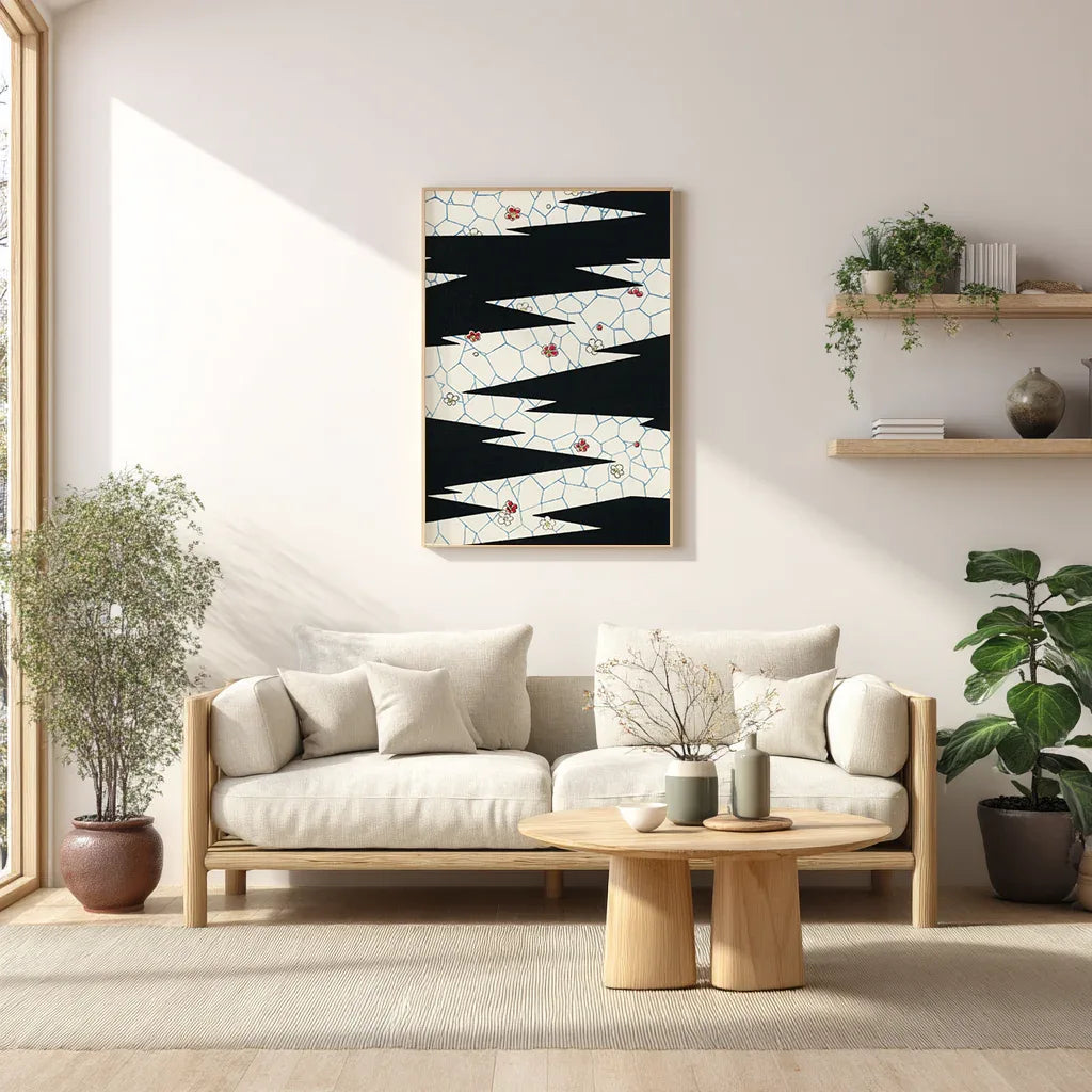 Framed abstract print with black zigzag pattern on cream background displayed above a sofa in a bright minimalist living room, styled with natural light and greenery for modern decor.
