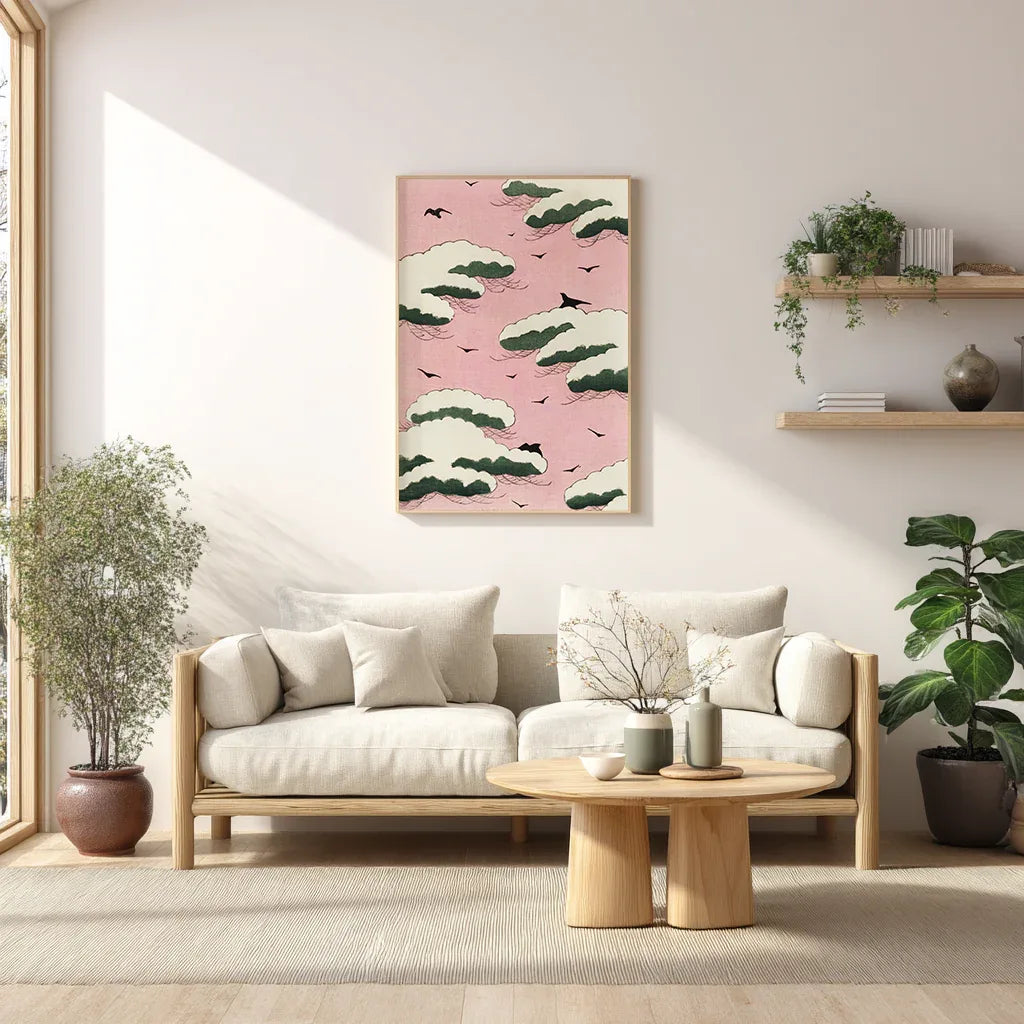 Japanese Shin Bijutsukai art print featuring a pink sky, white clouds and bird silhouettes hung above a sofa in a minimalist living room.