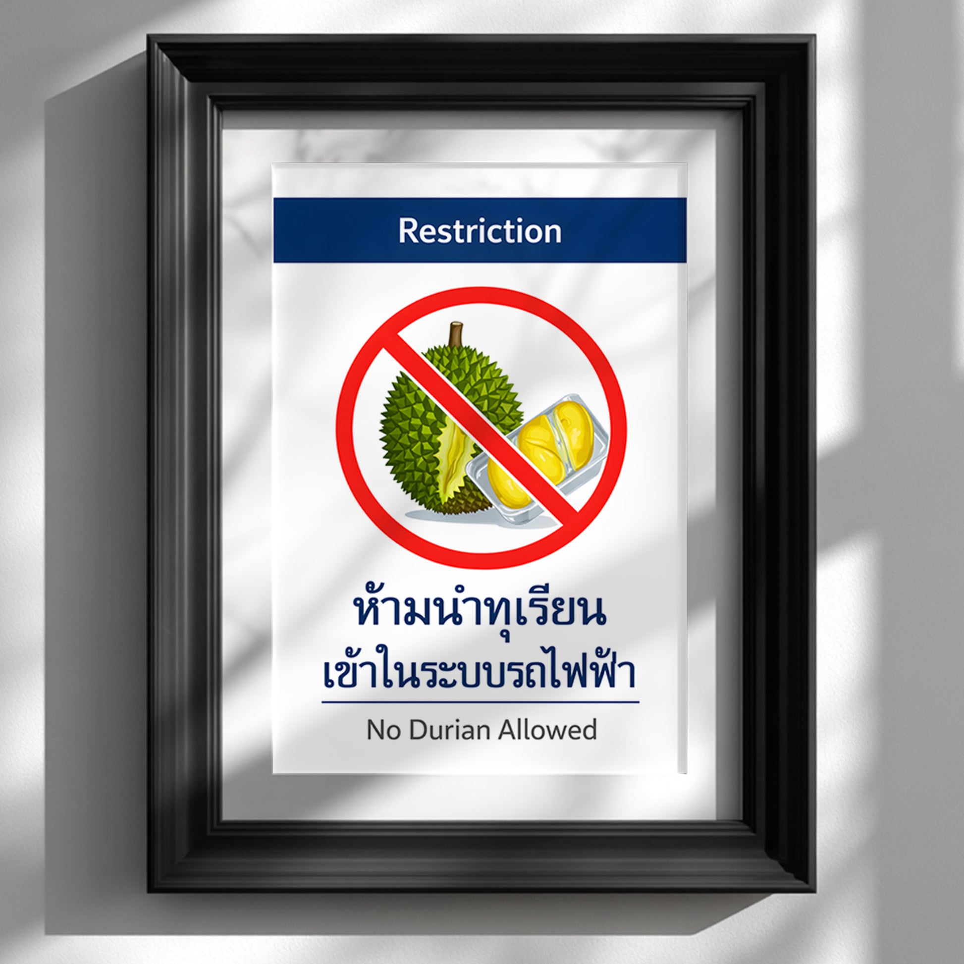 Framed No Durian Allowed poster inspired by Bangkok BTS and Thai metro system restriction signage, displayed in a black frame on a clean white wall. The minimalist bilingual prohibition sign features a bold red circle over a durian illustration with structured transport-style typography. A modern Southeast Asia travel memory print styled as graphic kitchen or hallway wall decor.