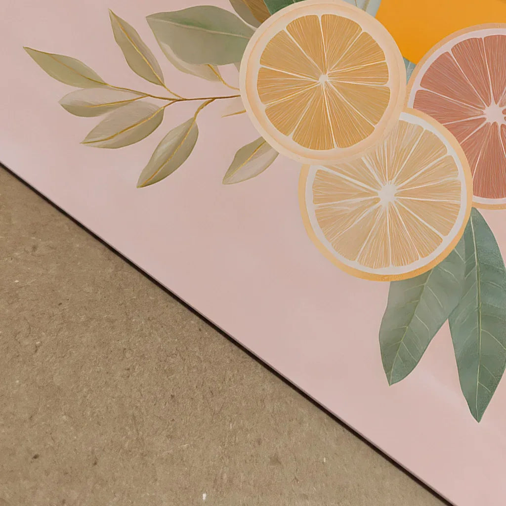 Close-up detail of the pastel citrus artwork showing the grapefruit, lemon, leaves and soft textures on the pink and beige split background, highlighting print clarity, colour depth and paper detail.