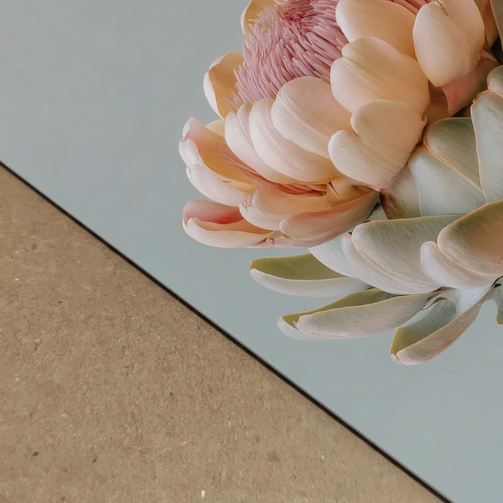 A close-up, detailed view of a pastel artichoke artwork showing soft petals, smooth textures and warm tones. The shallow depth of field and clean background highlight the botanical detail and modern art style.