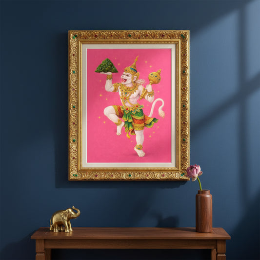 Thai Hanuman Ramakien art print presented in an ornate gold frame styled on a dark interior wall. The vivid pink background contrasts with the classical frame, showcasing the Hindu monkey god in traditional Thai costume. A striking spiritual mythology wall decor piece blending heritage Ramakien imagery with refined, gallery-style interior design.
