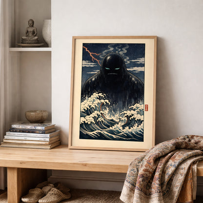 Framed Japanese wave and yōkai art print of the Umibōzu sea monk displayed on a wooden shelf with stacked books and folded neutral textiles. The design features powerful curling waves, deep blue water and a shadowed spirit figure beneath a stormy sky. A culturally inspired wall art piece combining traditional Japanese aesthetics with contemporary styling.