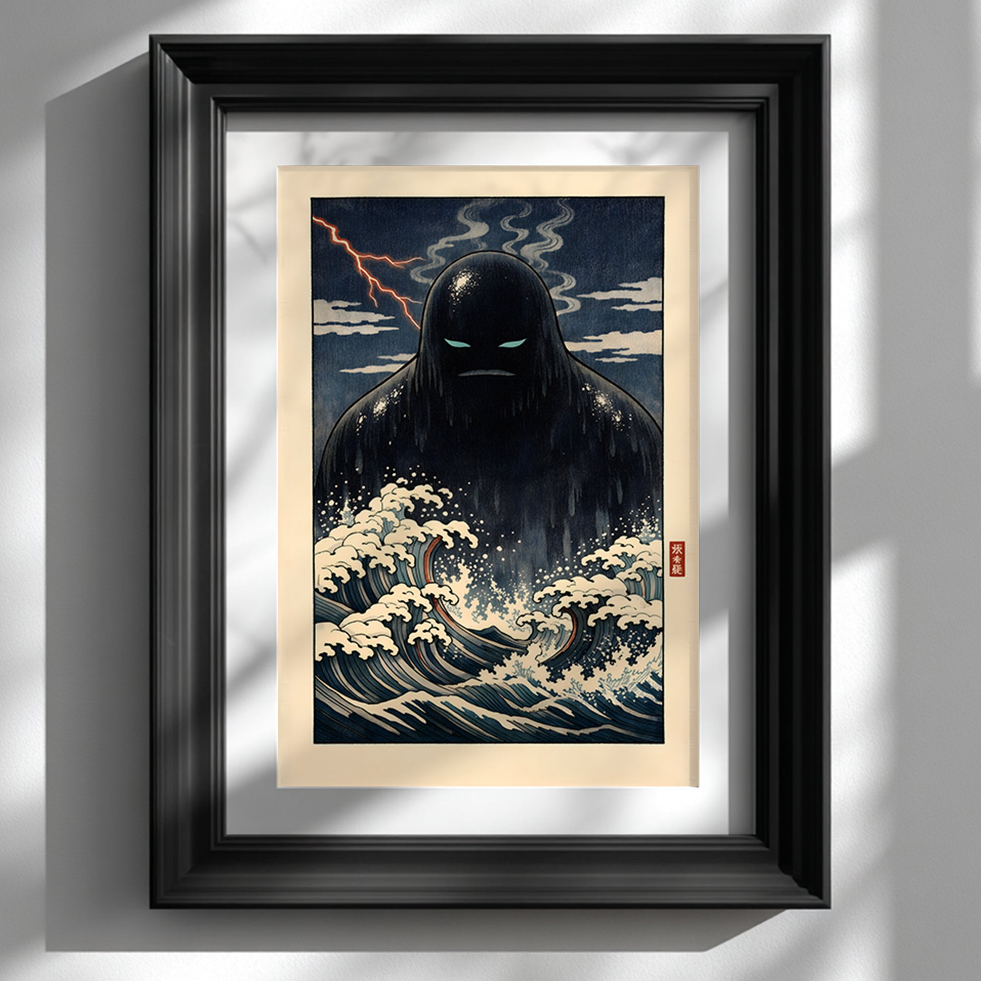 Framed Japanese yōkai wall art print featuring a dark Umibōzu sea spirit rising from stylised ocean waves, displayed in a black frame against a white wall. The artwork shows dramatic navy tones, foaming cream waves and a stormy night sky inspired by traditional Japanese woodblock aesthetics. A bold folklore statement piece for modern interiors and cultural art collections.